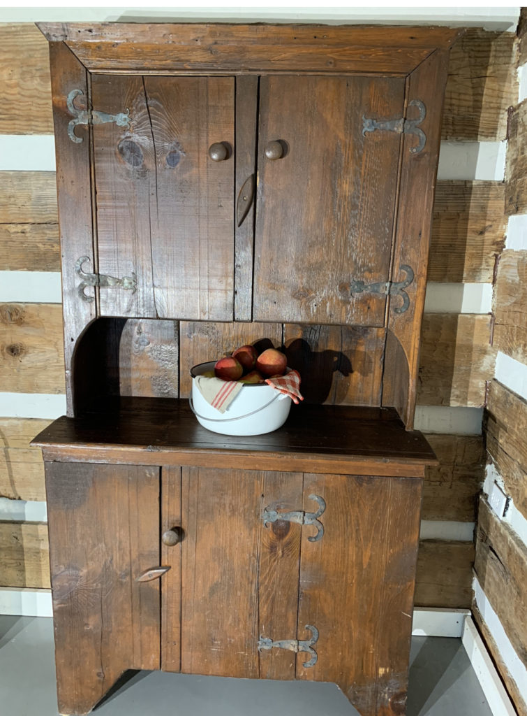 1700's antique hutch in a log cabin