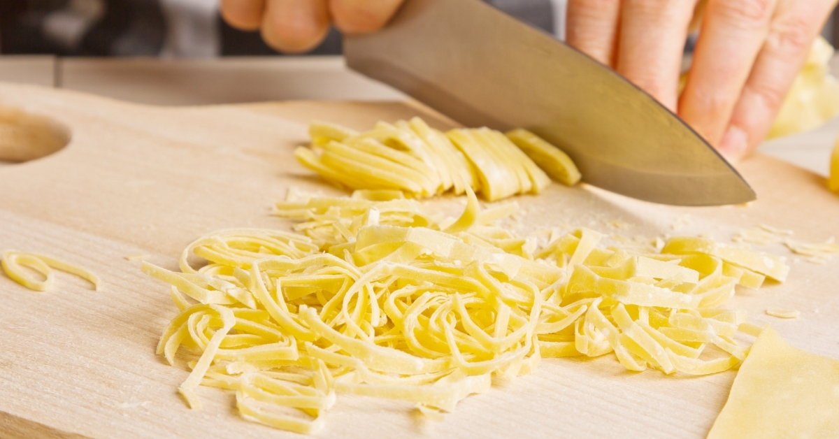 Cutting homemade egg noodle dough by hand