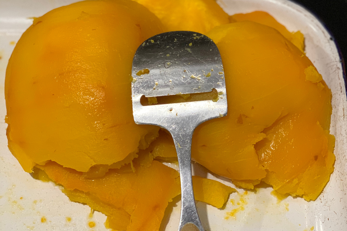 Easily scoop cooked pumpkins using a cheese slicer