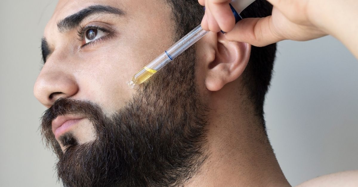 Applying beard oil to the beard